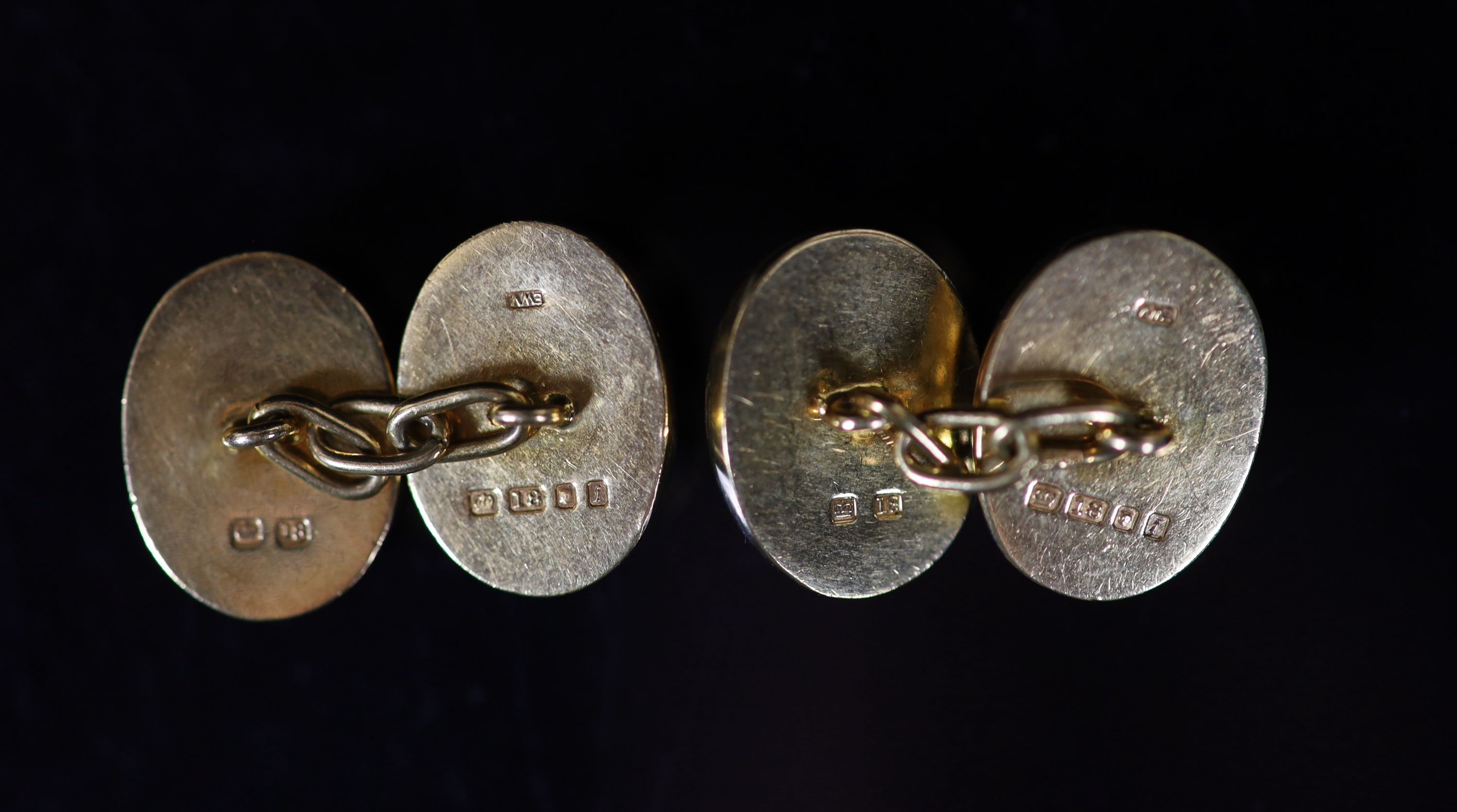 A pair of early 1960's 18ct gold and cabochon garnet set oval cufflinks